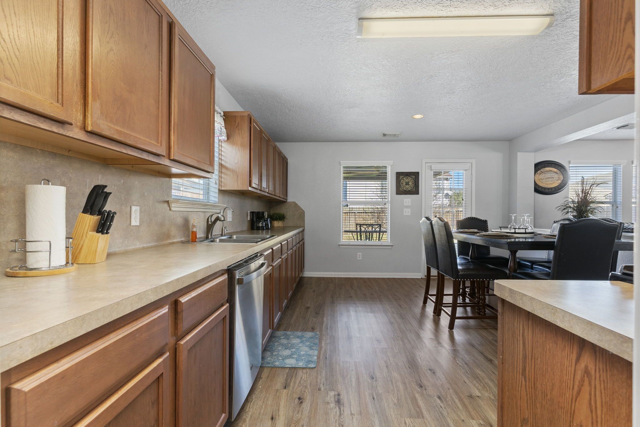 29326 Legends Green Drive Spring, TX 77386 - Photo 10 of 31 a kitchen with stainless steel appliances granite countertop a sink dishwasher a dining table and chairs with wooden floor