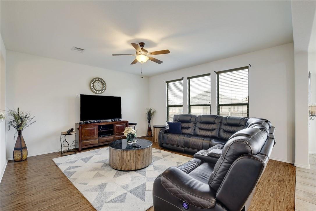 356 Matthews Kyle, TX 78640 - Photo 25 of 30 Relax in this comfortable living room featuring rich wood flooring and abundant natural light.