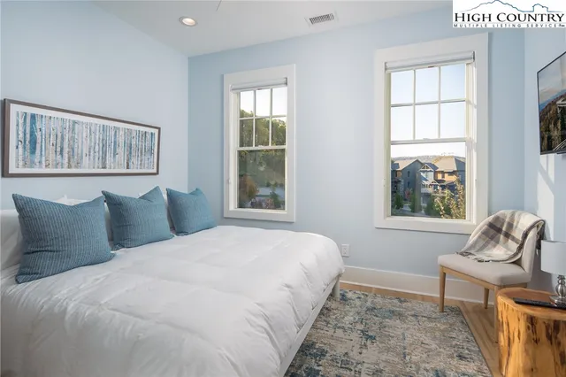 a bedroom with a large bed and a window