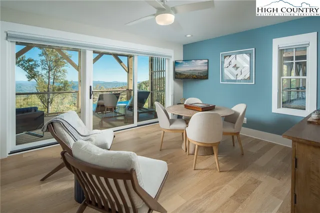 a bedroom with a bed and large windows