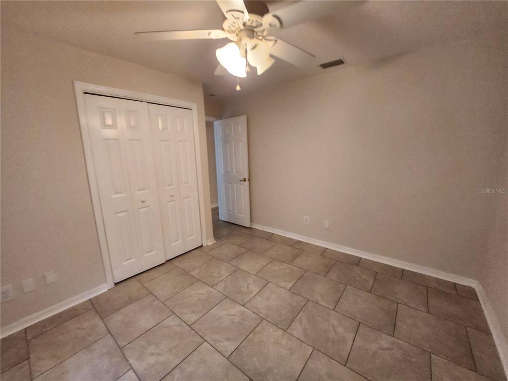 6521 East Grayson Street Inverness, FL 34452 - Photo 14 of 16 an empty room with closet and a chandelier fan