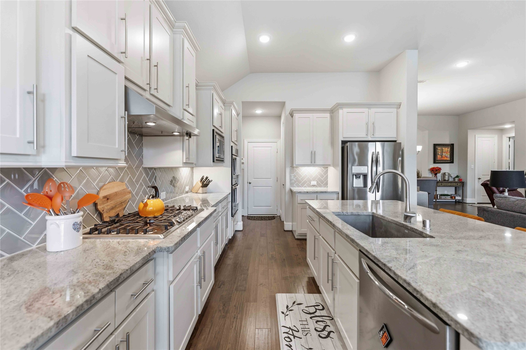 10127 Cooper's Hawk Way Conroe, TX 77385 - Photo 10 of 35 A bright chef's kitchen featuring sleek stainless steel appliances, double ovens, and plenty of cabinet and counter space, as well as a walk in pantry.
