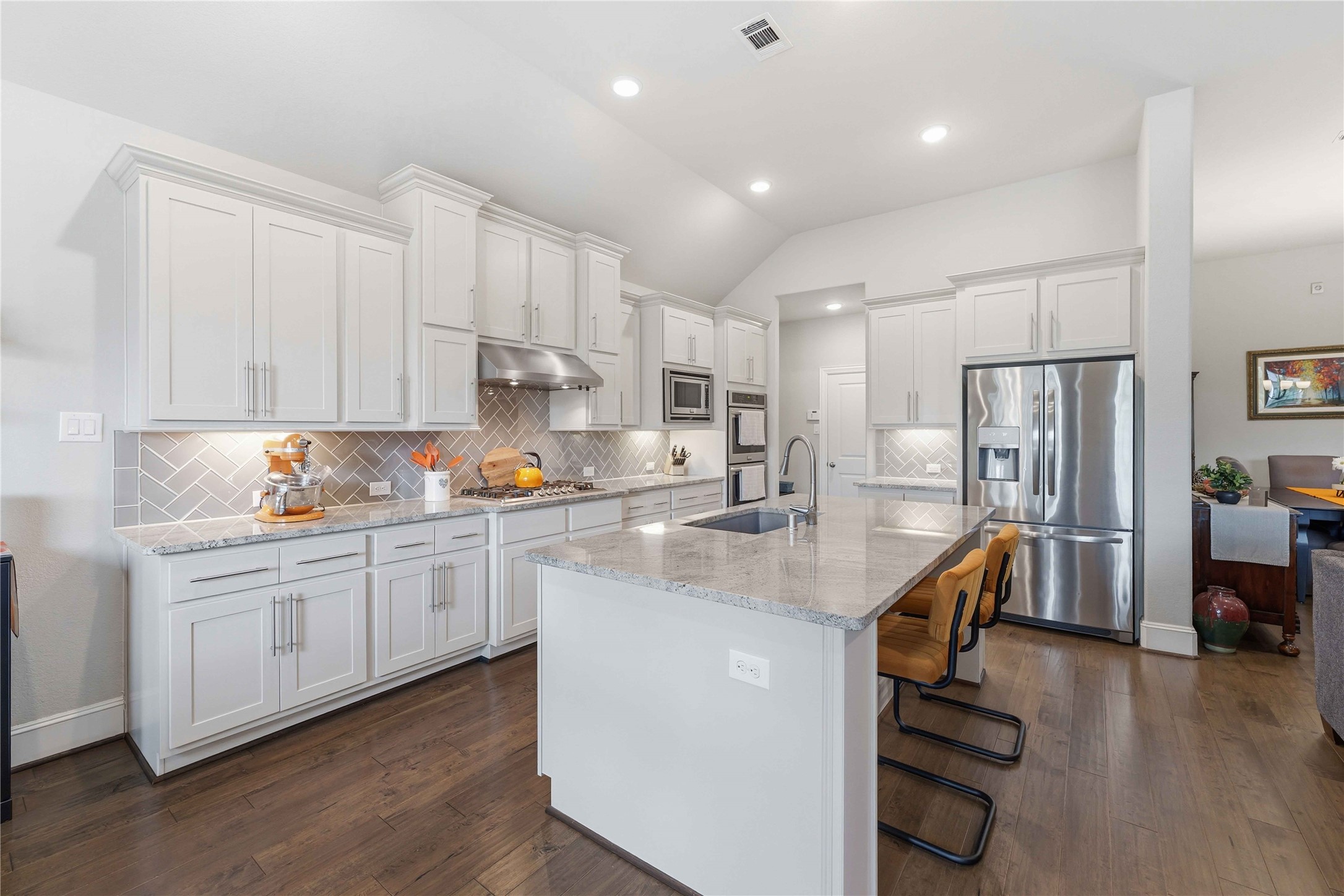 10127 Cooper's Hawk Way Conroe, TX 77385 - Photo 11 of 35 A bright chef's kitchen featuring sleek stainless steel appliances, double ovens, and plenty of cabinet and counter space, as well as a walk in pantry.