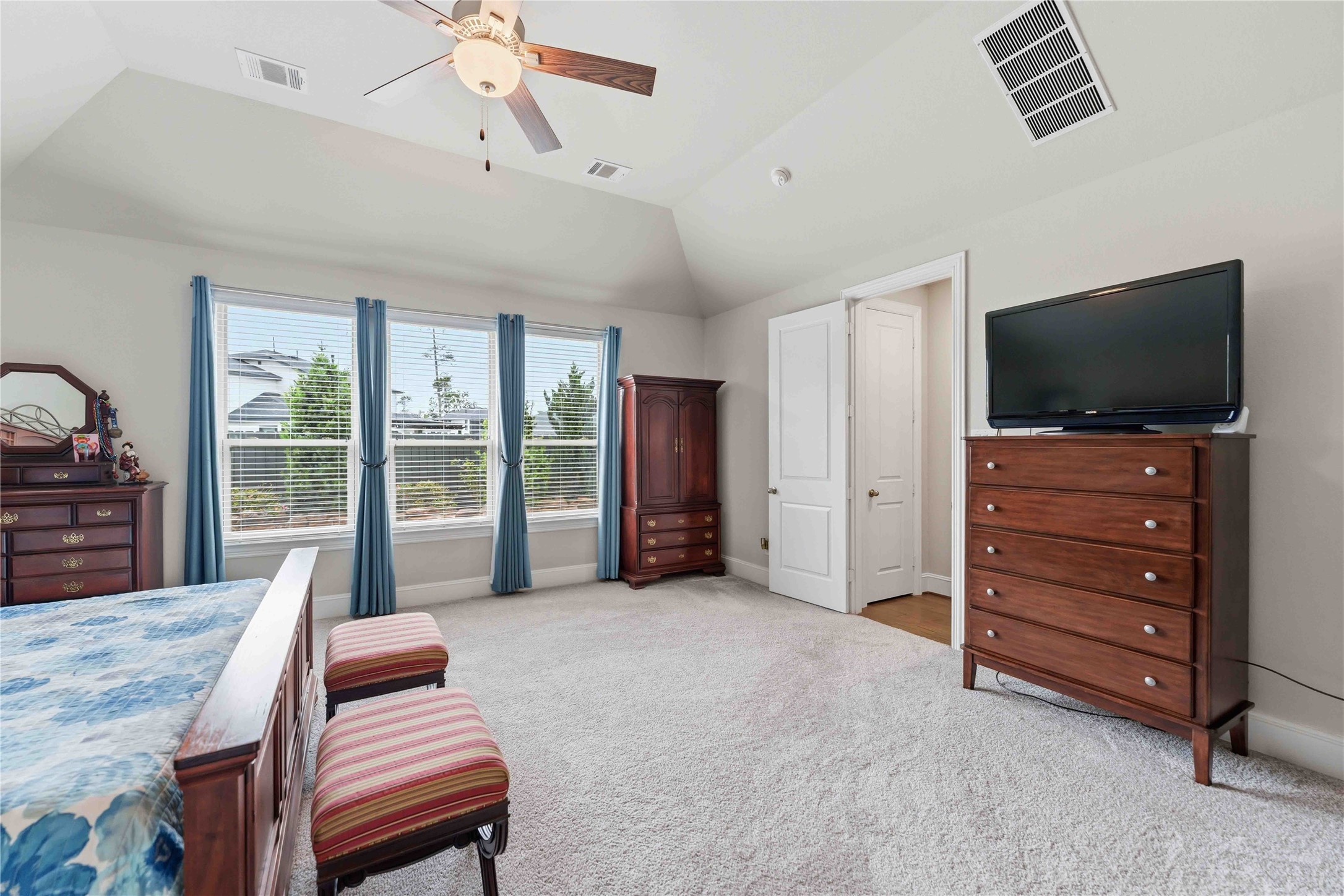 10127 Cooper's Hawk Way Conroe, TX 77385 - Photo 18 of 35 Extended primary bedroom offers relaxing views of the backyard