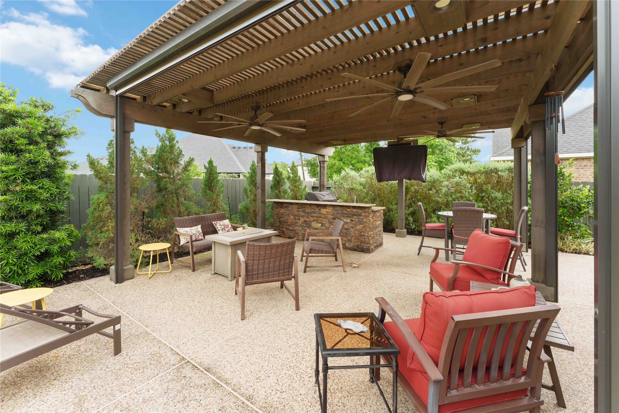 10127 Cooper's Hawk Way Conroe, TX 77385 - Photo 27 of 35 The pergola is smartly equipped with an outdoor kitchen, beverage cooler, plenty of space for relaxing, and motorized screens that offer privacy and year round enjoyment.