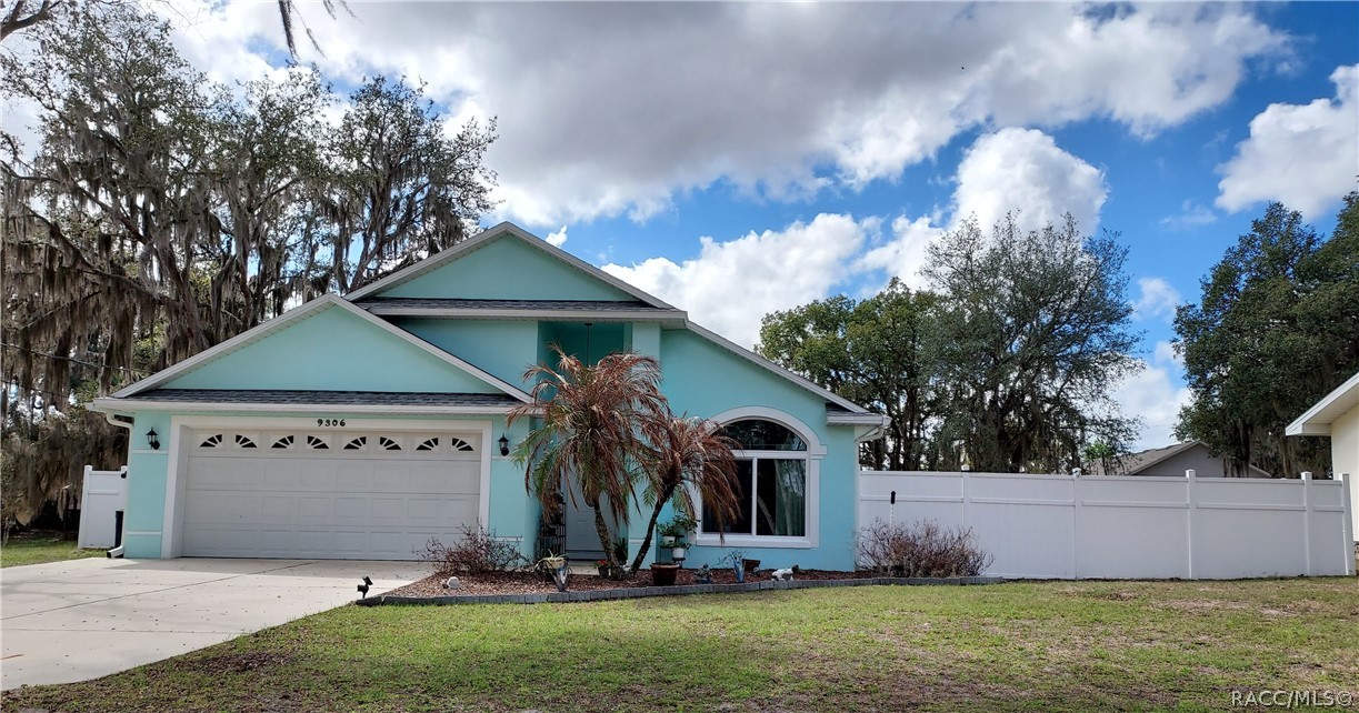 9306 East Gospel Island Road Inverness, FL 34450 - Photo 1 of 16 a front view of a house with garden