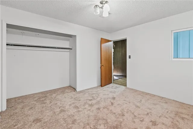 a view of an empty room with a chandelier