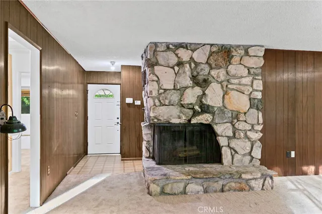 a stone house with a fireplace in front of it