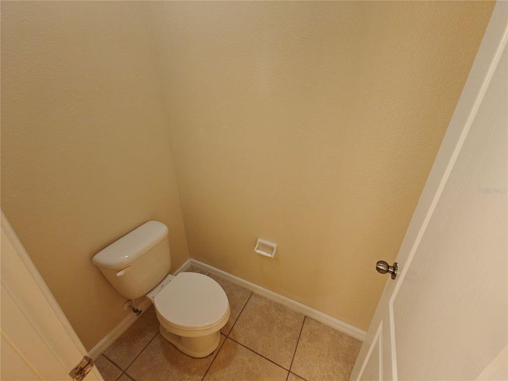 3410 Rodrick Circle Orlando, FL 32824 - Photo 11 of 27 a white toilet sitting next to a shower