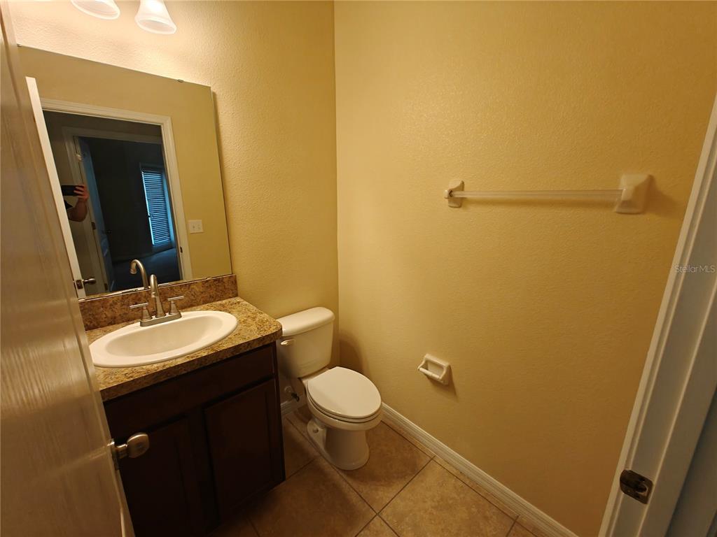 3410 Rodrick Circle Orlando, FL 32824 - Photo 7 of 27 a bathroom with a sink a toilet and mirror