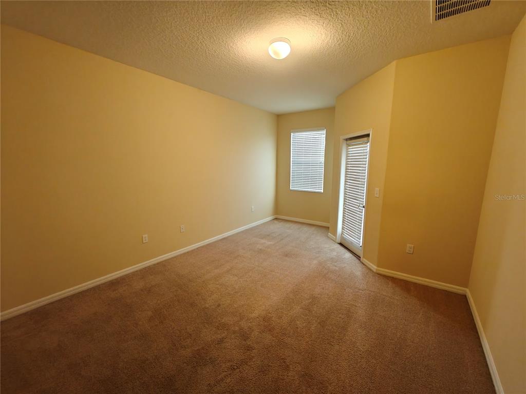 3410 Rodrick Circle Orlando, FL 32824 - Photo 8 of 27 an empty room with a empty space and a window