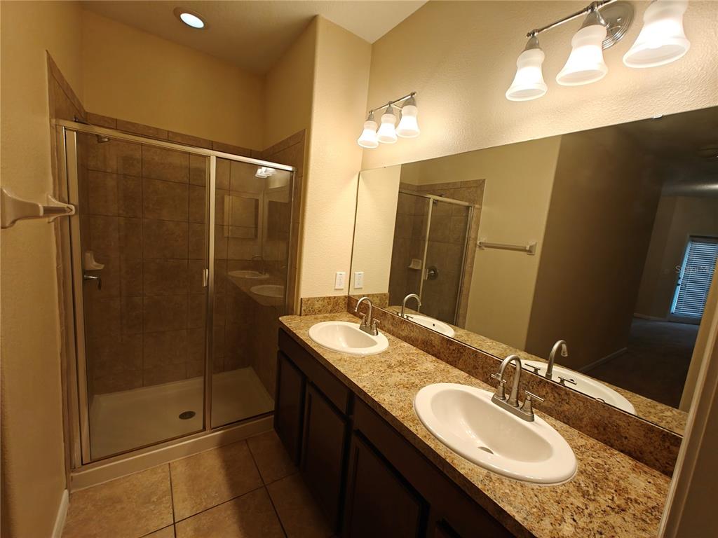 3410 Rodrick Circle Orlando, FL 32824 - Photo 10 of 27 a bathroom with a granite countertop sink mirror and shower