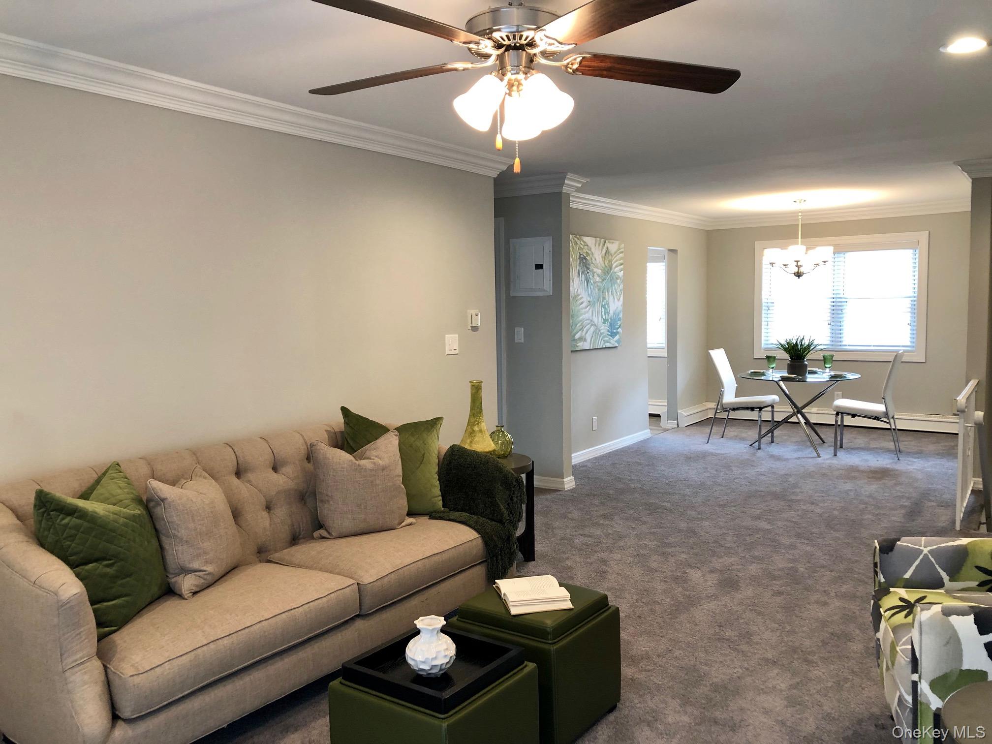 100 Terrace Road, Unit T03152 Bayport, NY 11705 - Photo 5 of 9 a living room with furniture a chandelier and a couch