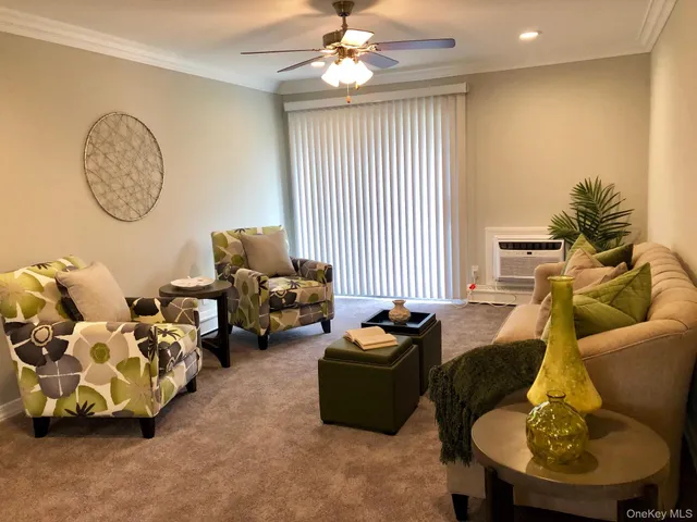a living room with furniture flowerpot and a window
