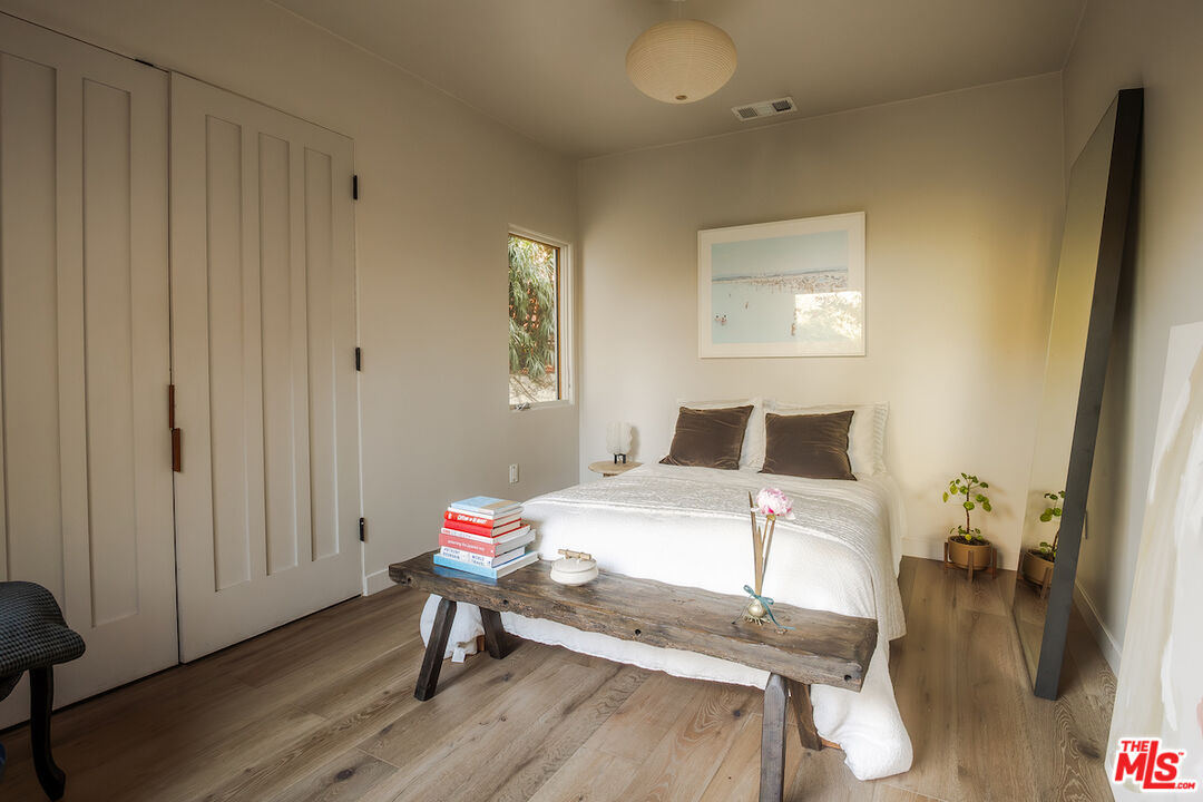 2139 Baxter Street Los Angeles, CA 90039 - Photo 20 of 55 a bedroom with a bed and wooden floor