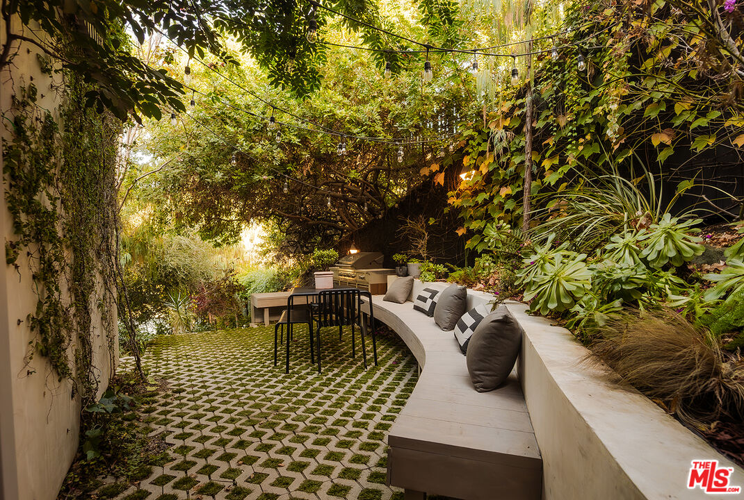 2139 Baxter Street Los Angeles, CA 90039 - Photo 40 of 55 a view of a patio with table and chairs with wooden fence and plants