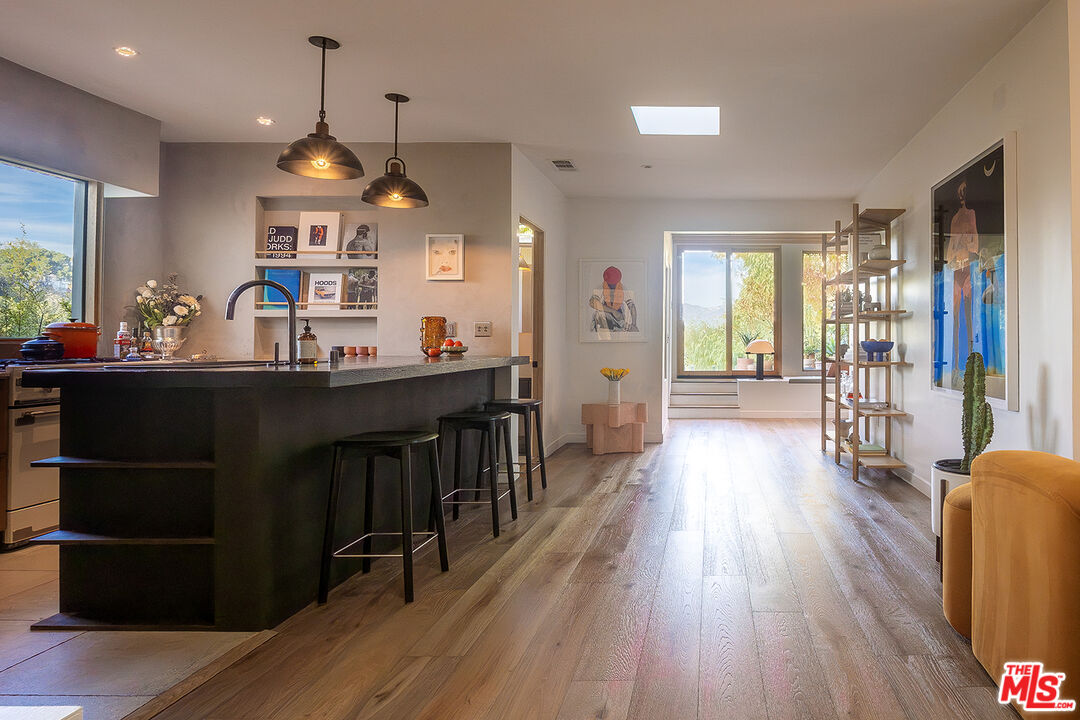 2139 Baxter Street Los Angeles, CA 90039 - Photo 9 of 55 a kitchen with stainless steel appliances granite countertop a refrigerator a sink dishwasher a stove and a dining table with wooden floor
