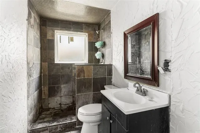 a bathroom with a sink toilet and mirror