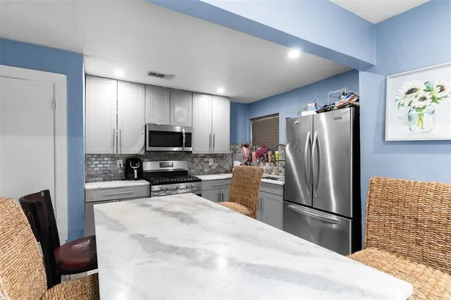 a kitchen with stainless steel appliances a refrigerator and a sink
