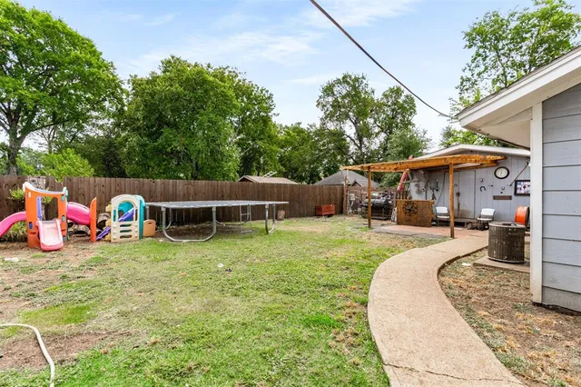 a view of a house with backyard sitting area and slide