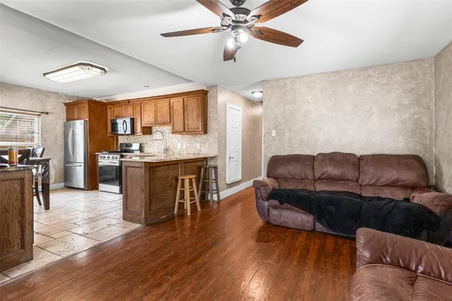 a living room with furniture and a wooden floor