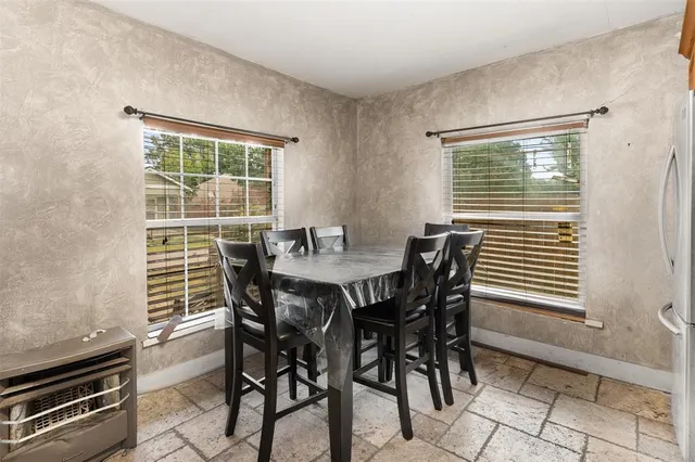 a view of a dining room with furniture and window