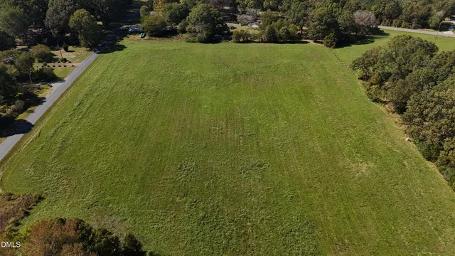 a view of a field of grass and trees