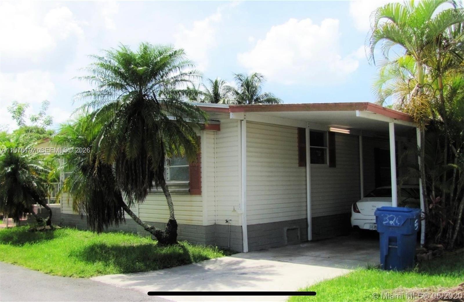 19800 Southwest 180th Avenue, Unit 320 Miami, FL 33187 - Photo 1 of 7 a front view of a house with garden