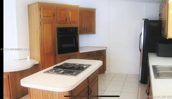 a kitchen with a sink a stove and refrigerator
