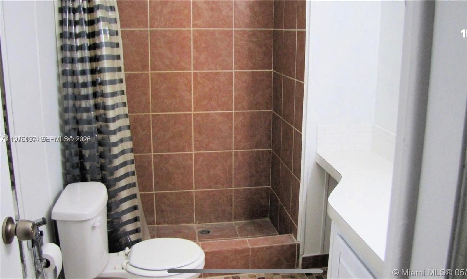 19800 Southwest 180th Avenue, Unit 320 Miami, FL 33187 - Photo 7 of 7 a bathroom with a toilet and a shower