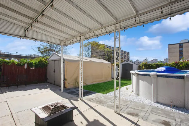 a view of a patio with a table and chairs under an umbrella