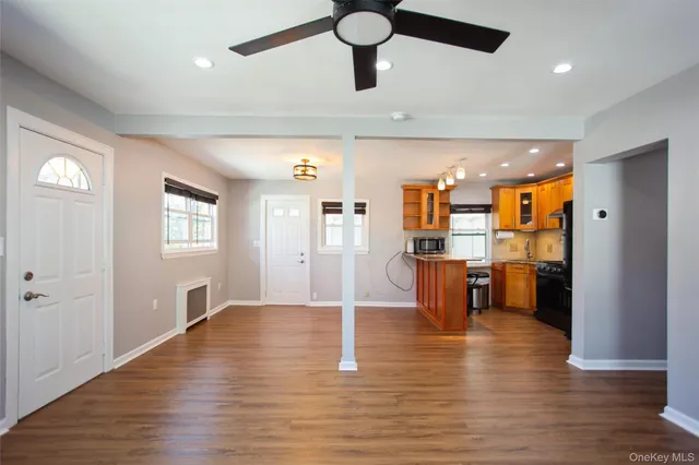 a view of a kitchen with refrigerator and wooden floor