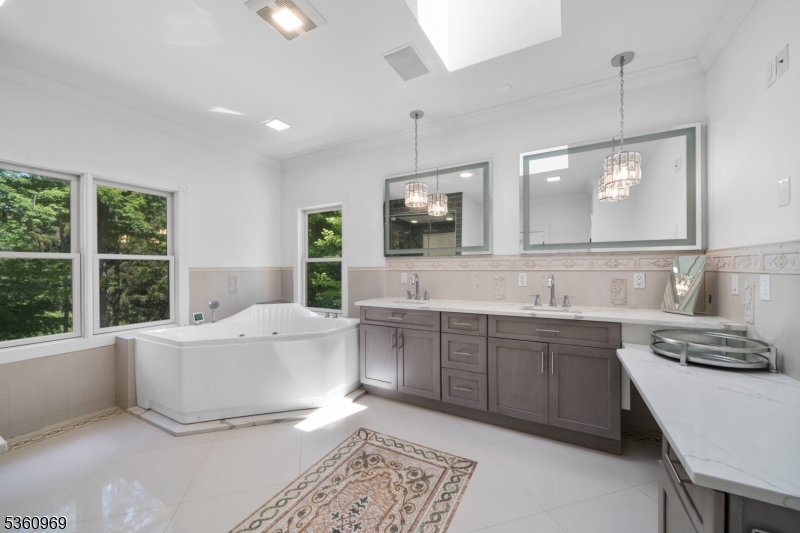 47 Cutlass Road Kinnelon, NJ 07405 - Photo 39 of 42 a bathroom with a double vanity sink a mirror and a bathtub