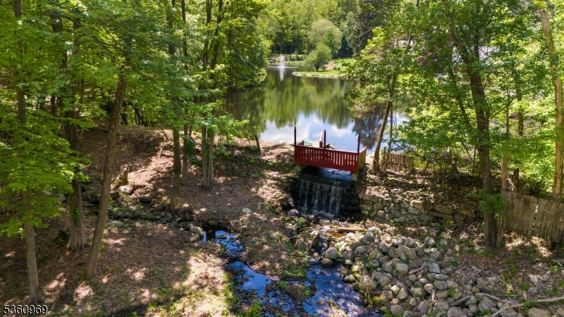 47 Cutlass Road Kinnelon, NJ 07405 - Photo 9 of 42 a view of a fire pit with large trees