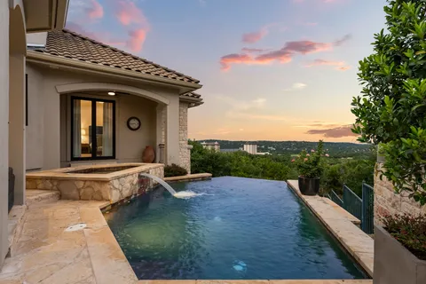 a view of a house with pool and a yard