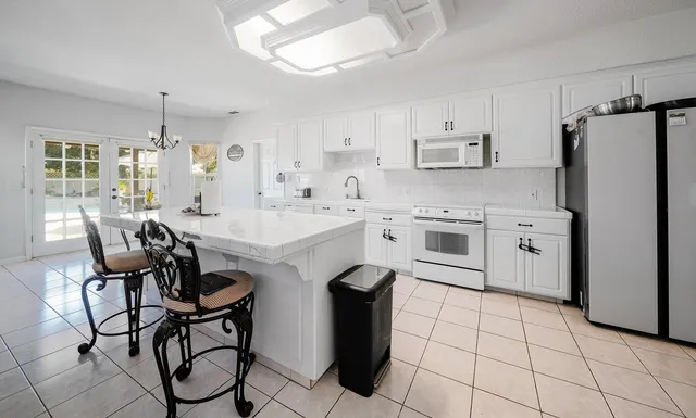 a kitchen with appliances cabinets and furniture