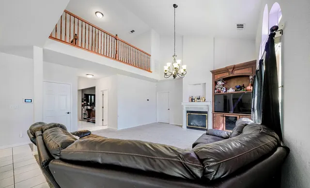 a living room with a couch and a chandelier
