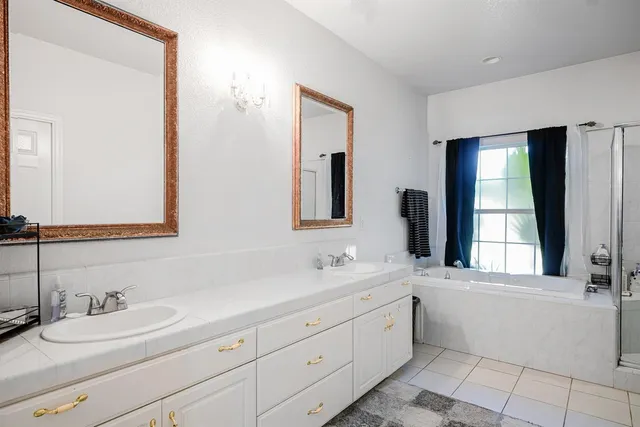 a bathroom with a double vanity sink and a mirror