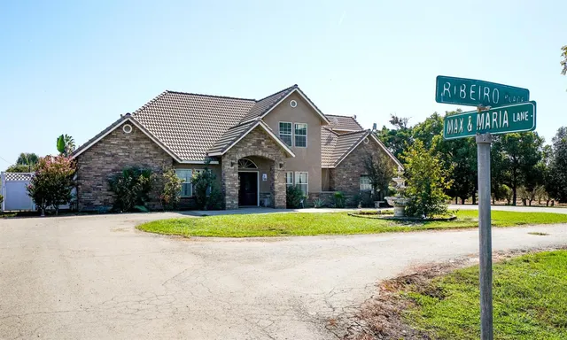 a front view of house with yard and trees