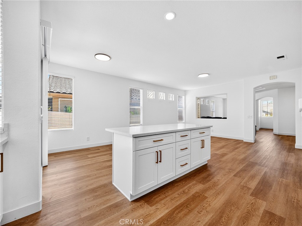 1436 Riviera Avenue Banning, CA 92220 - Photo 12 of 43 a room with a white bed cabinets and wooden floor