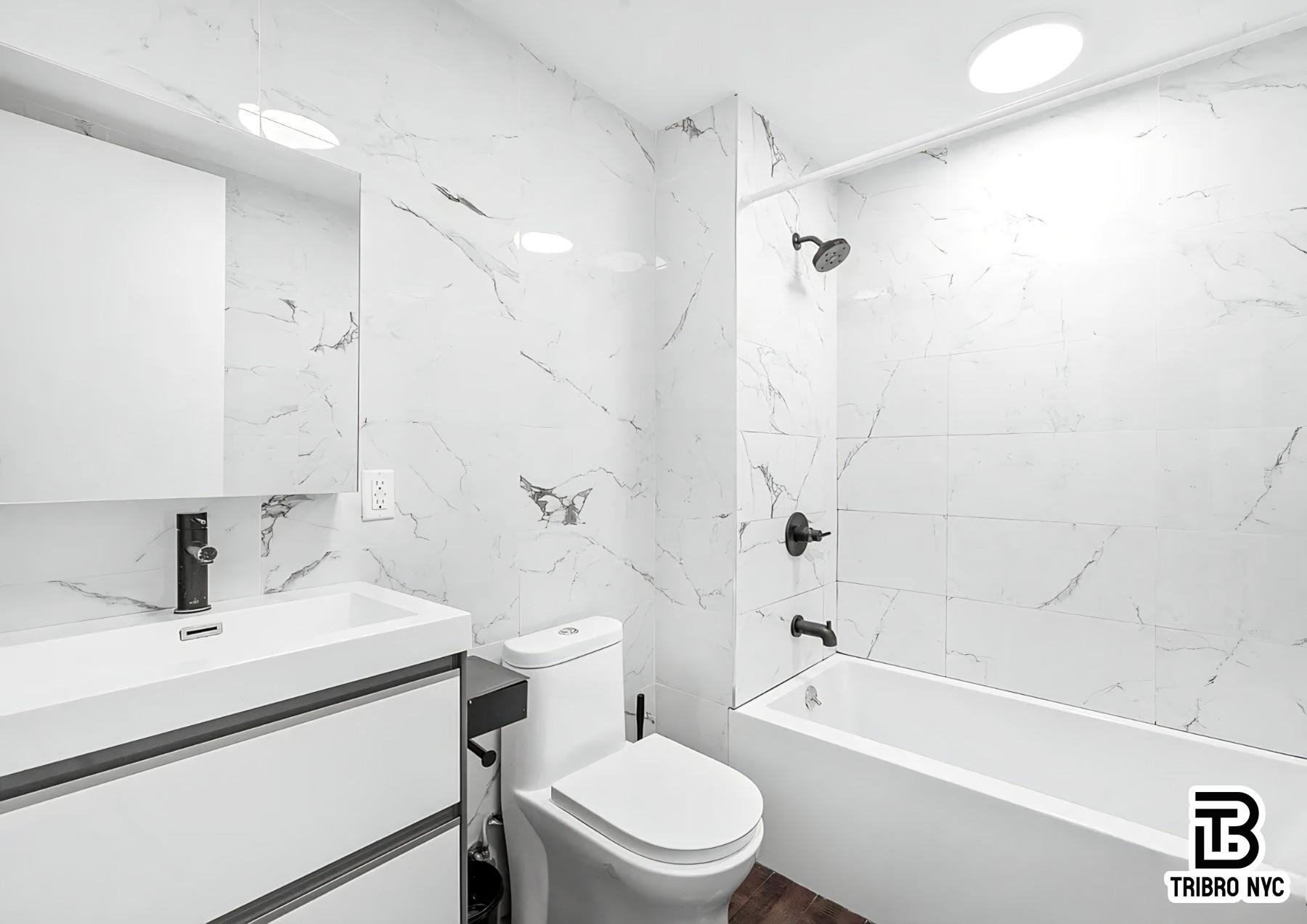 64 Stagg Street, Unit 4H Brooklyn, NY 11206 - Photo 7 of 7 a bathroom with a sink a toilet and a bathtub