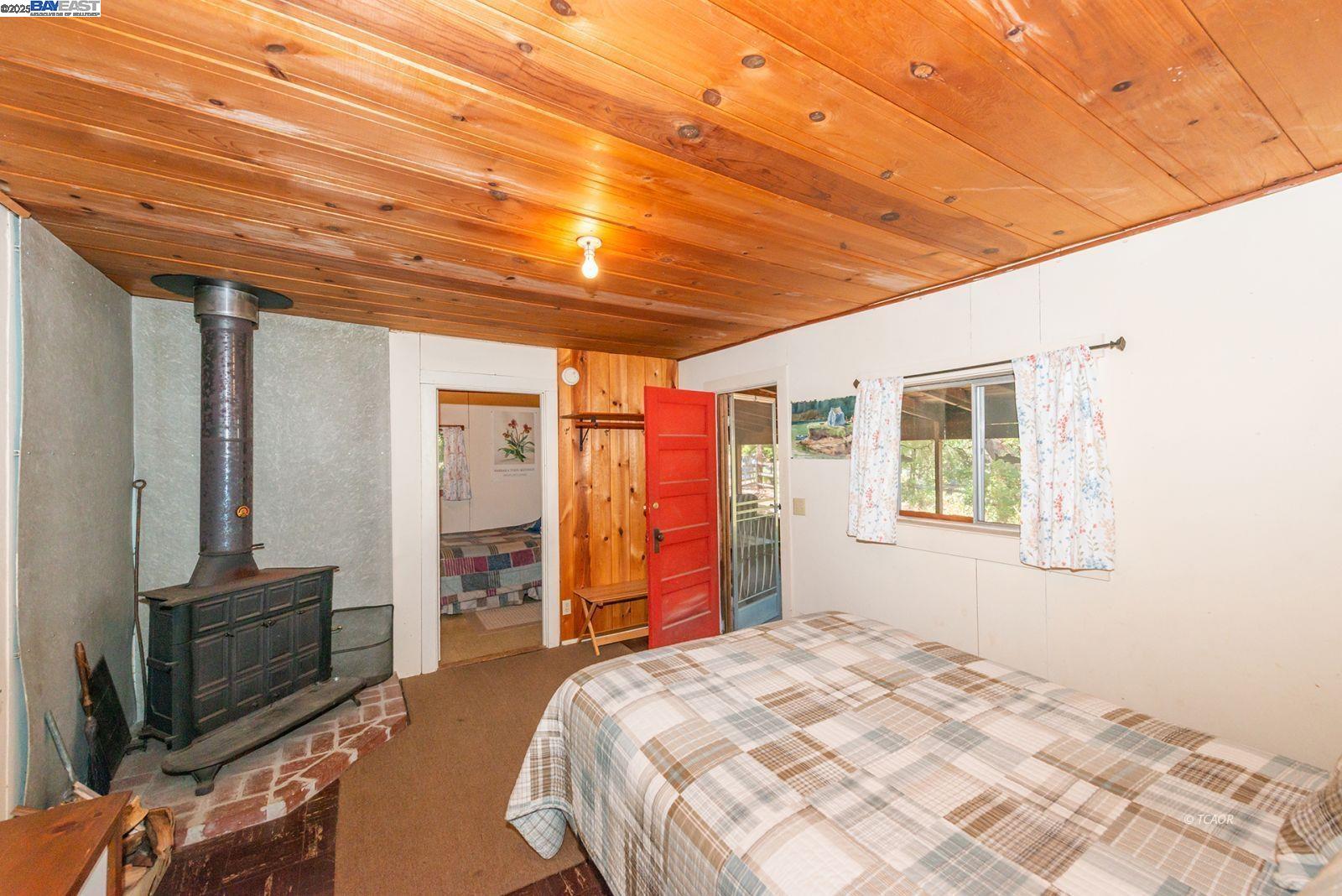 181 Price Creek Road Big Bar, CA 96010 - Photo 17 of 49 a bedroom with a large bed and a chandelier