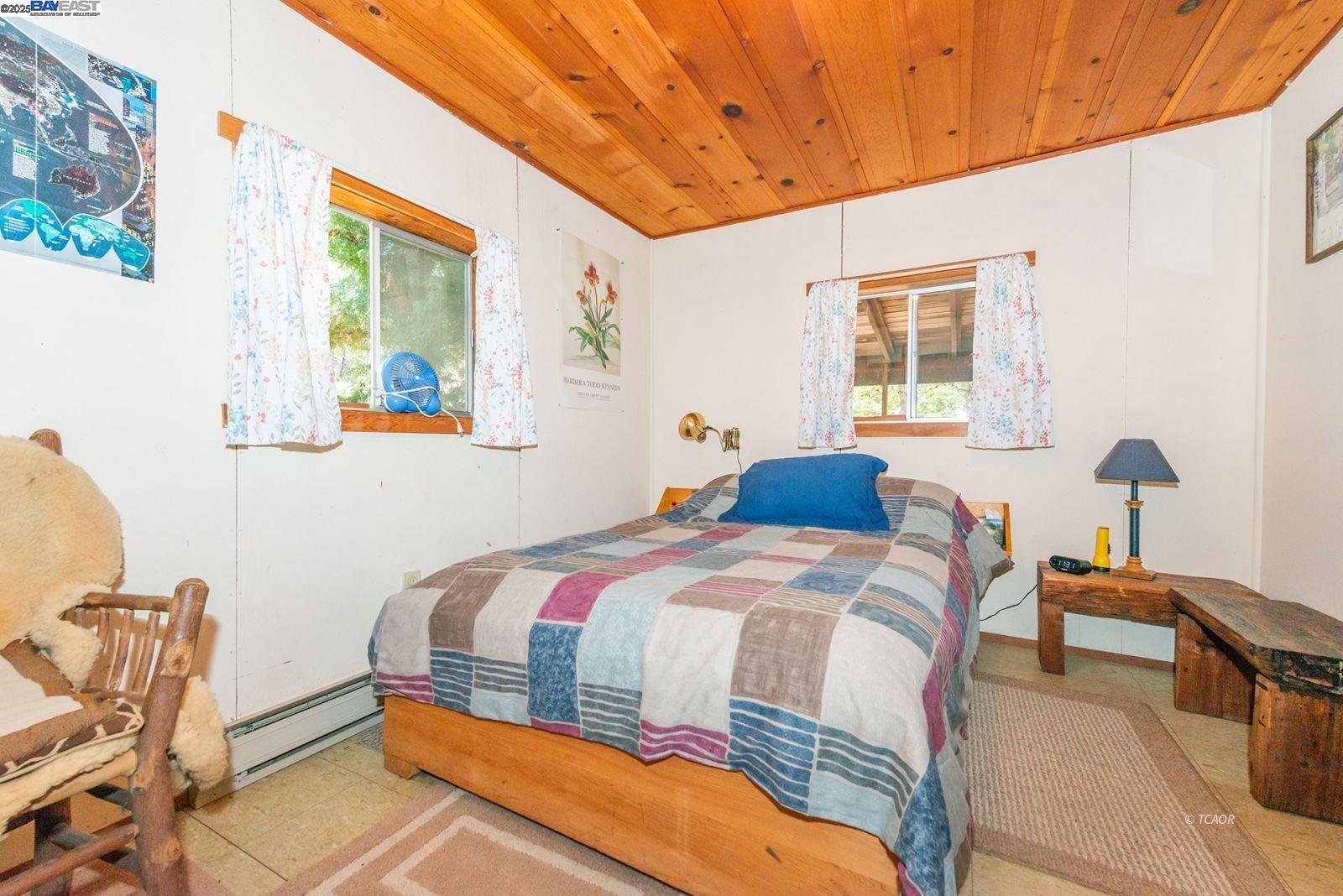 181 Price Creek Road Big Bar, CA 96010 - Photo 20 of 49 a bedroom with a bed and a table in it