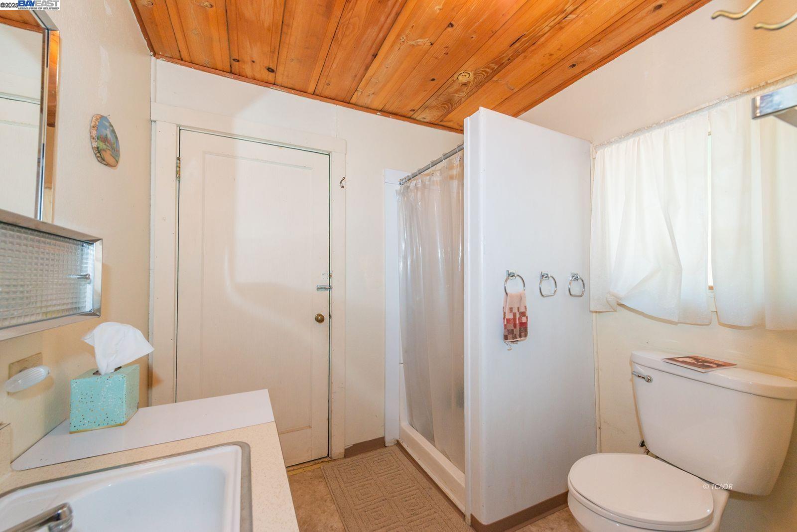 181 Price Creek Road Big Bar, CA 96010 - Photo 22 of 49 a white toilet sitting next to a bathroom sink and vanity