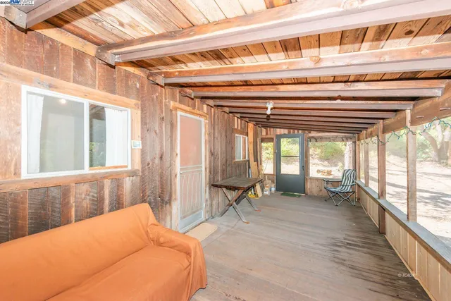a backyard of a house with wooden floor and fence