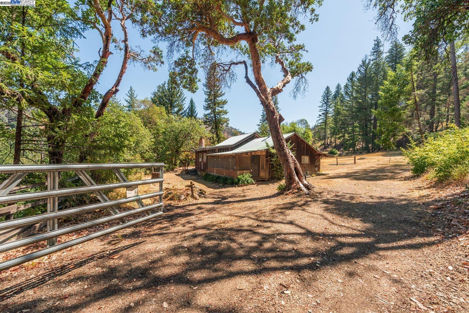 181 Price Creek Road Big Bar, CA 96010 - Photo 28 of 49 a backyard of a house with wooden floor and fence