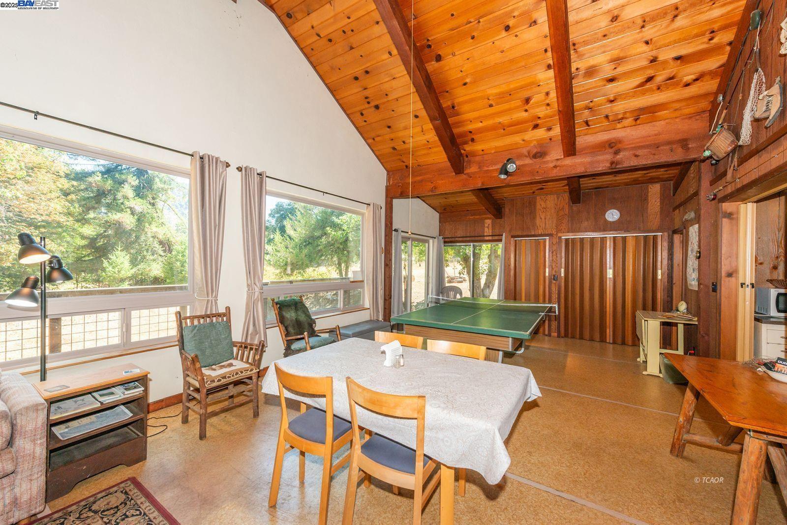 181 Price Creek Road Big Bar, CA 96010 - Photo 7 of 49 a view of a dining room with furniture wooden floor and a rug