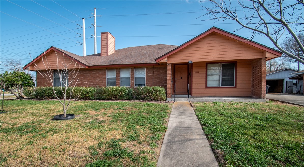 4502 Marie Street Corpus Christi, TX 78411 - Photo 1 of 26 a front view of a house with a yard