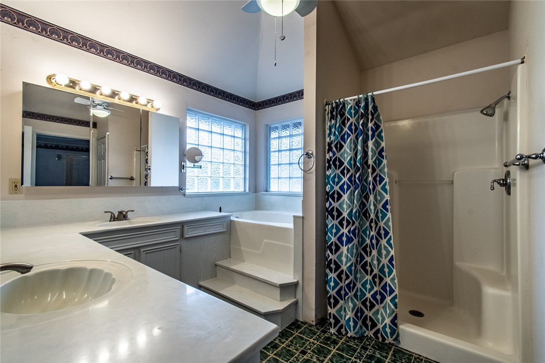 4502 Marie Street Corpus Christi, TX 78411 - Photo 13 of 26 a bathroom with a bathtub sink vanity and a shower
