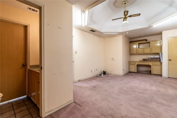 an empty room with closet and windows
